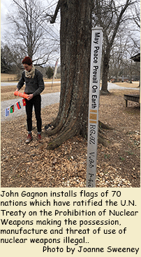 John Gagnon installs flags of the 70 nations which have ratified the U.N. Treaty on the Prohibition of Nuclear Weapons declaring nuclear weapons illegal
